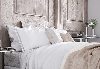 bed with pillows and blankets in a bedroom